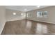 Spacious living room with hardwood flooring, lots of windows, and neutral walls at 125 Sharp Edge Ave, North Las Vegas, NV 89031