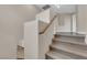 Carpeted staircase with wooden banister at 125 Sharp Edge Ave, North Las Vegas, NV 89031