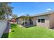 Lush backyard with well-maintained lawn, covered patio, and privacy fencing at 1520 Della Ct, Boulder City, NV 89005