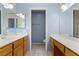Spacious bathroom with dual sinks, wood cabinets, and a large mirror for added convenience at 1520 Della Ct, Boulder City, NV 89005