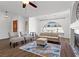 Bright living room featuring vaulted ceiling, wood floors, statement window, and comfortable seating at 1520 Della Ct, Boulder City, NV 89005