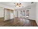 Bright main bedroom featuring hardwood floors, a ceiling fan, and access to the backyard at 1520 Della Ct, Boulder City, NV 89005