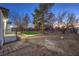 Expansive backyard with artificial turf, mature trees, and a patio area perfect for entertaining at 1731 Sherwin Ln, Las Vegas, NV 89156