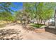 This backyard offers a mix of mature trees, a small grassy area, and a patio deck, perfect for relaxing and entertaining at 1731 Sherwin Ln, Las Vegas, NV 89156