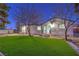 Backyard of home features modern artificial turf and fresh landscaping at 1731 Sherwin Ln, Las Vegas, NV 89156