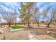 Backyard featuring new artificial turf, mature trees, and patio area from exterior view at 1731 Sherwin Ln, Las Vegas, NV 89156