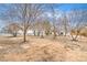 Picture of the fenced backyard featuring desert landscaping and a few mature trees, offering a private outdoor space at 1731 Sherwin Ln, Las Vegas, NV 89156