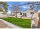 View of backyard with modern lawn, updated landscaping, and home exterior with sliding glass doors and small outdoor decks at 1731 Sherwin Ln, Las Vegas, NV 89156