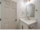 Bright bathroom featuring a modern white vanity, gold fixtures, and an arched mirror at 1731 Sherwin Ln, Las Vegas, NV 89156