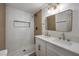 Bright bathroom features dual sinks, modern lighting and a tiled walk-in shower at 1731 Sherwin Ln, Las Vegas, NV 89156