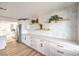 Bright kitchen with white cabinets, stainless steel appliances, and floating shelves at 1731 Sherwin Ln, Las Vegas, NV 89156