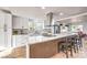 Bright kitchen features white cabinets, stainless appliances and large island with seating at 1731 Sherwin Ln, Las Vegas, NV 89156