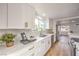 Bright kitchen with white cabinetry, quartz countertops, and stainless steel appliances at 1731 Sherwin Ln, Las Vegas, NV 89156