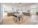 Bright, open-concept living room featuring modern decor, laminate flooring, and a view into the dining and kitchen area at 1731 Sherwin Ln, Las Vegas, NV 89156