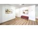 Bright living room features modern art, an upholstered bench and light wood flooring at 1731 Sherwin Ln, Las Vegas, NV 89156