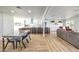 Open living space with modern dining table, kitchen island, and comfortable living room arrangement at 1731 Sherwin Ln, Las Vegas, NV 89156