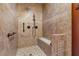 Luxurious tiled shower featuring a built-in seat and elegant fixtures, offers a spa-like experience at 2151 Bannerwood St, Henderson, NV 89044