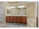 Spacious bathroom featuring a double vanity, soaking tub, and a separate shower area for comfort at 2151 Bannerwood St, Henderson, NV 89044
