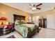 Elegant bedroom features a beautifully crafted wooden bed frame and luxurious green bedding at 2151 Bannerwood St, Henderson, NV 89044