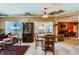 The dining room features a round table, tile floors, and sliding glass doors to an outdoor living space at 2151 Bannerwood St, Henderson, NV 89044