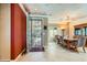 Formal entryway with a wrought iron door, adjacent to a dining area with elegant chandelier at 2151 Bannerwood St, Henderson, NV 89044