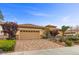 Inviting single-story home with lush landscaping, brick driveway, and a spacious two-car garage at 2151 Bannerwood St, Henderson, NV 89044