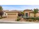 Charming single-story home featuring a well-manicured front yard, desert landscaping, and a two-car garage at 2151 Bannerwood St, Henderson, NV 89044