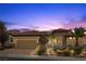 Lovely home showcasing a front entrance with stone accents, lush greenery, and a three car garage at 2151 Bannerwood St, Henderson, NV 89044