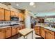 Well-equipped kitchen with wood cabinetry, granite countertops, and an open design at 2151 Bannerwood St, Henderson, NV 89044