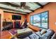 Comfortable living room with a fireplace, exposed beams, and a view of the pool area at 2151 Bannerwood St, Henderson, NV 89044