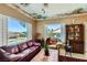 Living room features a view of the pool, a large window, plantation shutters, and a decorative ceiling at 2151 Bannerwood St, Henderson, NV 89044