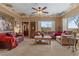 Spacious living room featuring cozy seating, a coffee table, and bright windows at 2151 Bannerwood St, Henderson, NV 89044