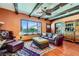 Spacious living room features hardwood floors, exposed beams, a ceiling fan, and a view of the backyard at 2151 Bannerwood St, Henderson, NV 89044