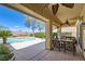 Charming covered patio featuring comfortable seating and views of the beautiful pool and landscaping at 2151 Bannerwood St, Henderson, NV 89044