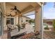 Relaxing covered patio seating area with ceiling fan and view of the sparkling pool at 2151 Bannerwood St, Henderson, NV 89044