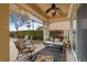 Comfortable covered patio seating area with fan and view of the lush backyard landscaping and pool at 2151 Bannerwood St, Henderson, NV 89044