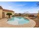 Backyard pool with tanning ledge surrounded by mature landscaping and outdoor lighting at 2151 Bannerwood St, Henderson, NV 89044