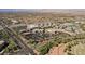Scenic aerial view of the community, featuring shopping centers, residential buildings, and well-planned roads with lush greenery at 2185 High Mesa Dr, Henderson, NV 89012