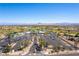 Scenic aerial view of the community, highlighting lush landscaping, a golf course, and ample parking at 2185 High Mesa Dr, Henderson, NV 89012