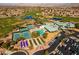 Wide aerial view of the community clubhouse amenities, including tennis courts, pool, and bocce ball at 2185 High Mesa Dr, Henderson, NV 89012