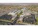 Panoramic aerial view showcasing the neighborhood's blend of commercial, retail, and residential areas with palm tree-lined streets at 2185 High Mesa Dr, Henderson, NV 89012