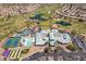 Expansive aerial view of community amenities featuring golf course, pool, clubhouse, and tennis and pickleball courts at 2185 High Mesa Dr, Henderson, NV 89012