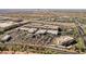 Expansive aerial view highlighting the community's commercial and retail centers, featuring ample parking and attractive buildings at 2185 High Mesa Dr, Henderson, NV 89012