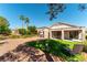 Private backyard oasis featuring lush green lawn, desert landscape, covered patio, and ample space for outdoor living at 2185 High Mesa Dr, Henderson, NV 89012