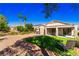 A spacious backyard featuring artificial grass, gravel landscaping, and a covered patio at 2185 High Mesa Dr, Henderson, NV 89012