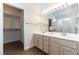 Bathroom featuring a double sink vanity, wood-look floors, and a walk-in closet at 2185 High Mesa Dr, Henderson, NV 89012