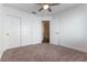 Bedroom with ceiling fan, double closets, and neutral carpeting at 2185 High Mesa Dr, Henderson, NV 89012