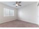 A bedroom features neutral carpet, a ceiling fan, and a window with blinds at 2185 High Mesa Dr, Henderson, NV 89012