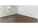 Well-lit room with tile flooring, white walls, baseboards, and a large window that brings in natural light at 2185 High Mesa Dr, Henderson, NV 89012