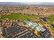 Aerial view showcasing the community's golf course, clubhouse, pool, tennis courts, and desert landscaping at 2185 High Mesa Dr, Henderson, NV 89012